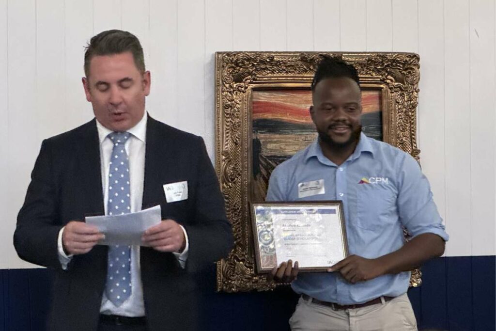 Photo of Archy Kahondo receiving his IAQ Future Leader Infrastructure Scholarship 2023